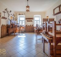 Interior of dining spaces with wooden furniture and themed decorations on the walls.
