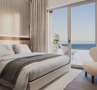 Bedroom with a bed in a 4-room apartment, with a sea view, wooden decor flooring.