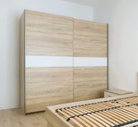 In the bedroom of a three-room apartment with a wooden decor floor, there is a wardrobe.
