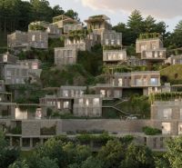 A cascading villa in Dhërmi set into a wooded slope with plenty of greenery.