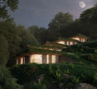 A villa in Dhërmi illuminated by moonlight, surrounded by a forest.