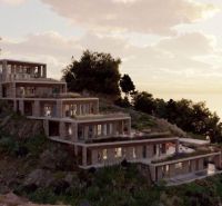 A villa in Dhërmi set on a hillside overlooking the sea and the surrounding landscape.