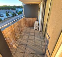 The balcony of a 2-room apartment on Pod hájom Street, Košice - Lorinčík district, with tiles and a shade.