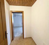 Interior of a family house with a wooden ceiling and paneling, floor with wooden decor.
