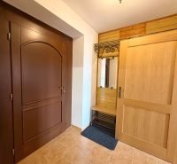 Interior of a family house with wooden decor doors and a practical coat rack.