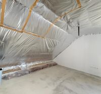 Attic room with insulation and ready for finishing in a family house.