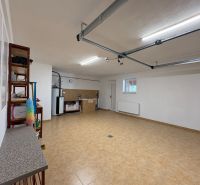 A garage with a shelf and a work area in a family house.