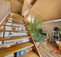 Wooden stairs and furniture in the interior of a family house with a wooden decor floor.