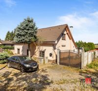 A family house in Veľké Leváre, a car on the driveway, a garden, and part of the fence.