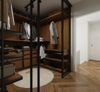 A wardrobe in a family house with shelves, mirrored doors, and a wooden decor floor.
