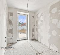 Unfinished room in a family house with drywall walls and a window.