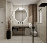 Bathroom in a family house with a large round mirror and a shower screen.