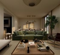 Living room in a family house with a comfortable green sofa, a coffee table, and candlesticks.