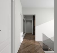 A hallway in a family house with a wooden decor floor and white walls.