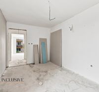 Unfinished room with white walls, electrical wiring, and construction boards in a family house.