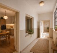 Interior of a family house with a kitchen and hallway, wooden decor flooring, plants.
