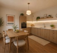 A kitchen with a table and chairs, a floor with a wooden decor, light wood, plants.