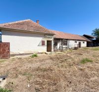 A family house in Hruboňovo with land and farm buildings in the countryside.