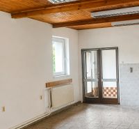 Interior of a family house with a wooden ceiling and ceramic floor.
