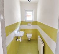 A bathroom in a family house with ceramic tiles and sanitary ware.