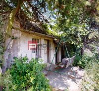 A family house on Štefánikova Street in Skalica, surrounded by trees and a swing in the yard.