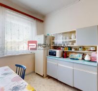 A kitchen in a family house with retro furniture, appliances, and a large window with a view.