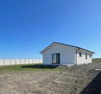 A family house in Bellova Ves with a white facade and a grassed garden.