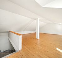 Attic interior with wooden decor flooring, suitable for residential properties.