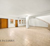 Spacious room with tiles and wooden doors, suitable for residential land.