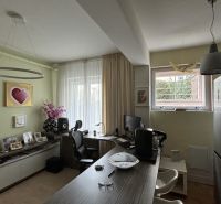 Study in a villa with equipment including a desk, chair, and decorations.