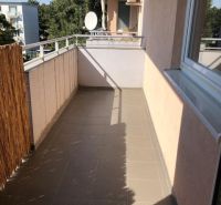 A balcony in a 2-room apartment with a view, tiles and railing in Bratislava-Ružinov.