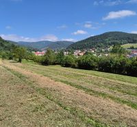 Plots - living in Nesluša, surrounded by green hills and scattered buildings.
