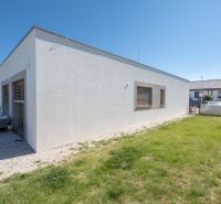 A family house in Trenčianske Jastrabie with a white facade and a manicured lawn.