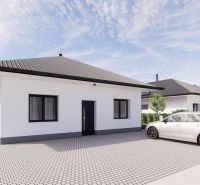 A family house in Prašník with a white facade, gray roof, and adjacent parking lot.