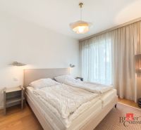 A bedroom in a 4-room apartment with a comfortable bed and a floor with a wooden decor.