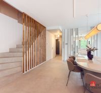 Dining room and stairs in a 4-room apartment with minimalist furniture and decoration.