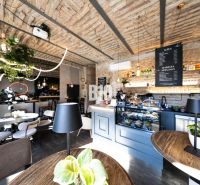 Stylish gastro spaces with brick vaults, greenery, and floors with a wooden decor.