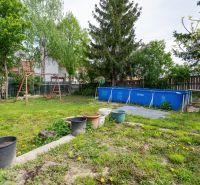A garden with a swimming pool and a swing on a residential plot in Dunajská Lužná, Kováčska.