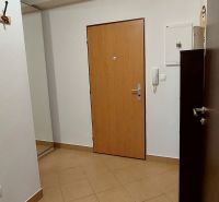 Entrance hall in a 3-room apartment with a coat rack and tiled floor.