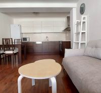 Living room in a 3-room apartment with a kitchen, floor with a wood decor.
