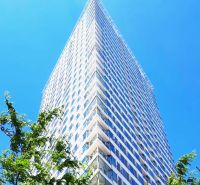 A high-rise building on Landererova Street in Bratislava - Staré Mesto under a blue sky.