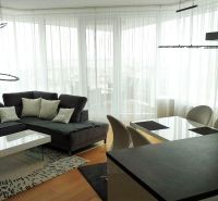 Living room with a corner sofa and a dining table in a 3-room apartment.