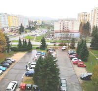 View from a 3-room apartment on Krivánska Street in Banská Bystrica with a parking lot and panel buildings.