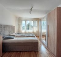 A bedroom in a 3-room apartment with a comfortable bed and a floor with a wooden decor.