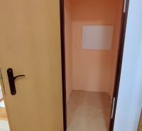 An open door compartment in a 2-room apartment with ceramic tiles on the floor.
