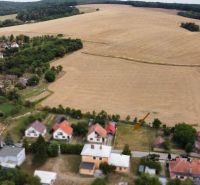 Aerial view of properties - housing in Podbranč surrounded by fields and greenery.