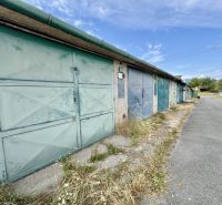 A row of garage doors in Detva on an asphalt road.