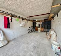 Garages in Detva with a bicycle, a shelf, and storage space.