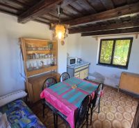 A dining room in a cabin with a wooden decor floor and rustic furnishings.