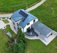 A family house on Osloboditeľov in Zborov with photovoltaic panels on the roof and a well-maintained garden.